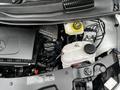 The engine compartment of a 2020 Mercedes-Benz Metris showing the engine assembly and various fluid reservoirs