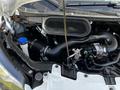 Engine compartment of a 2022 Ford Transit showcasing the air intake and various mechanical components
