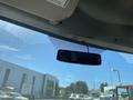 A rearview mirror hanging from the windshield of a 2020 Chevrolet Express showing a clear view through the glass