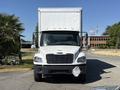 A white 2015 Freightliner M2 106 box truck with a silver cargo area and a black front bumper facing directly toward the viewer