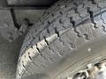 Close-up of a tire with a rugged tread pattern mounted on a vehicle rim