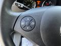 Close-up of a steering wheel control panel from a 2017 Mercedes-Benz Sprinter featuring buttons for navigation and menu selection