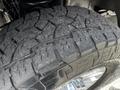 Close-up of a rugged tire tread on a 2020 Ford F-350 Super Duty showcasing deep grooves and a robust design for off-road performance