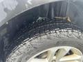 Close-up of a wet tire from a 2016 Ford Explorer showcasing the tread pattern and alloy wheel