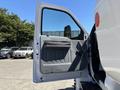A 2019 Ford F-750 with its driver's door open showing the interior door panel and side mirror