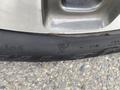 Close-up of a tire on a 2015 Kia Sorento showing the tread pattern and sidewall markings including the snowflake symbol indicating winter suitability