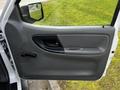 A 2010 Ford Ranger passenger door with a gray interior panel featuring a door handle and a manual window crank