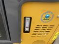 A close-up view of the control panel of a 2024 AGT Industrial H13R Mini Excavator featuring a gauge and an environmental protection agency label