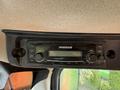 A car audio system with a display and various control buttons labeled with AM USB AUX and others