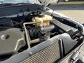 Close-up of the engine compartment of a 2013 Ford F-250 SD showing various components including hoses and the air intake system