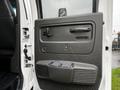 A white 2005 GMC C5 Duramax truck door with a gray panel featuring a door handle power window controls and a speaker grille