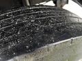 Close-up of a textured tire tread from a 2013 Ford F-650 showing wear and debris on the surface