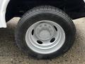 Close-up of a silver wheel and tire from a 2009 Ford F-550 showcasing the tread pattern and wheel design