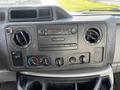 Dashboard controls of a 2013 Ford Econoline featuring the radio air conditioning knobs and vents