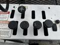 Control panel with five round buttons labeled for boom operation including down front stabilizer up and anti-twist function on a 2008 International 7500