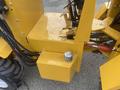Close-up of a 2024 AGT KRW 23 Mini loader showing its yellow metal chassis hydraulic lines and a component with a cap located on the side