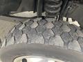 Close-up of a worn tire on a 2017 Ford F-550 showing a textured tread pattern and a silver wheel rim