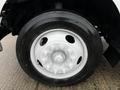 Close-up of a Goodyear tire mounted on a white wheel of a 2013 Ford F-650 showing the lug nuts and rim design