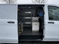 A 2019 Mercedes-Benz Metris van with its side door open revealing organized storage shelves and metal containers inside