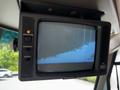 A Panasonic television mounted on the wall of a 2000 Ford Motorhome with buttons for standard, contrast, and brightness settings