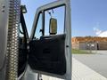 A 2009 International 7500 truck with the driver's door open and side mirror visible