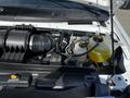 Close-up view of the engine compartment of a 2019 Ford Econoline showing various components including the air intake and coolant reservoir