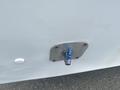 A metal water inlet connection with a blue valve attached to it on a vehicle surface