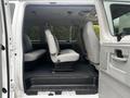 Interior of a 2008 Ford Econoline showing three gray seats arranged along the sides with a spacious floor area and door opening to the outside