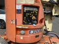 A 2009 JLG E300AJP boom lift with operational controls and safety warnings visible on the control panel