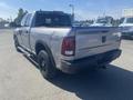 A 2021 RAM 1500 pickup truck in silver with a black bed liner and wheels featuring the Warlock trim designation