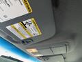 Interior view of a 2015 Ford F-450 SD showing overhead lights and warning labels on the visor