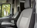 Interior view of a 2022 Ford Transit with two gray cloth seats featuring armrests and a minimalist design.