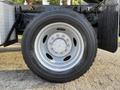 Close-up of a gray wheel of a 2006 Ford F-550 showcasing the tire tread and silver rim with visible lug nuts