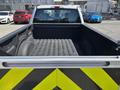 A 2016 Ford F-150 truck with an empty bed viewed from the back showing the lining and taillights