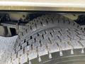 Close-up of a rugged tire from a 2020 Chevrolet Silverado showcasing deep tread patterns and sturdy construction