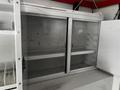 Interior view of a 2013 Ford Econoline with empty shelves and compartments designed for storage