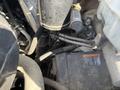 Close-up view of the engine compartment of a 2013 Chevrolet Express showing various components including wiring and hoses