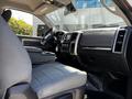 Interior of a 2015 RAM 5500 showing a driver's seat dashboard and controls with a focus on textile seat design and modern technology features
