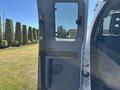 A 2016 Ford F-550 door partially open showing the interior door panel and a small window with a vent below it