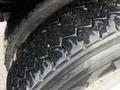 Close-up of a heavy-duty tire with a rugged tread pattern designed for off-road and industrial use