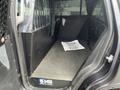 Interior view of a 2016 Chevrolet Tahoe with a metal partition and a flat floor space featuring a mat that says Thank You for Your Service