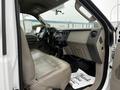 Interior of a 2008 Ford F-450 SD with a beige leather seat and dashboard controls visible along with a floor mat marked "Thank You"