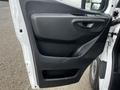 Interior door panel of a 2021 Mercedes-Benz Sprinter featuring a black textured surface and a handle