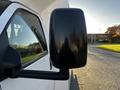 Close-up of the side mirror of a 2017 Chevrolet Express with a black casing and visible reflections on the surface