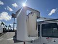 A white 2008 Ford Econoline van with a utility bucket attachment on the side, used for aerial work at heights