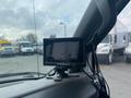 A 2016 Chevrolet Express with a mounted black monitor on the dashboard