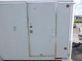 A white office trailer measuring 18 feet with a plain door featuring a keyhole and a small sticker on it