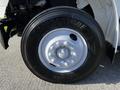A close-up of a Freightliner M2 106 truck tire featuring a Bridgestone logo white wheel rim and multiple lug nuts