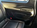 The interior side door panel of a 2022 Mercedes-Benz Metris featuring a black finish with a speaker grill and door lock switch