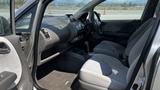 Interior view of a 2006 Honda Fit showcasing the front seats and dashboard featuring controls and a gear shift